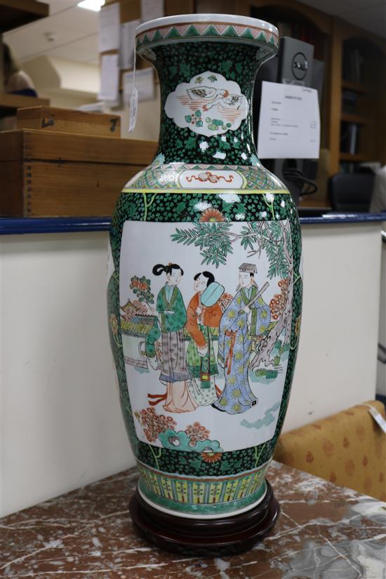 A pair of large Chinese porcelain vases with hardwood stands